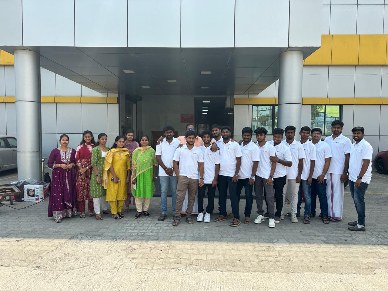The Adhiran Infotech team lined up outside the Chennai office, many wearing company polo shirts