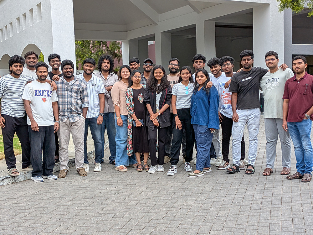 Team group photo outside a colonnaded building during an offsite